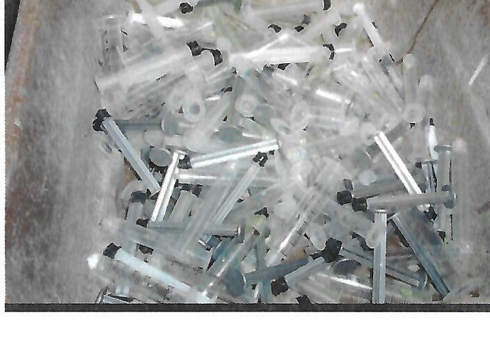 Used syringes retained together in a basin in the shelter euthanasia room
